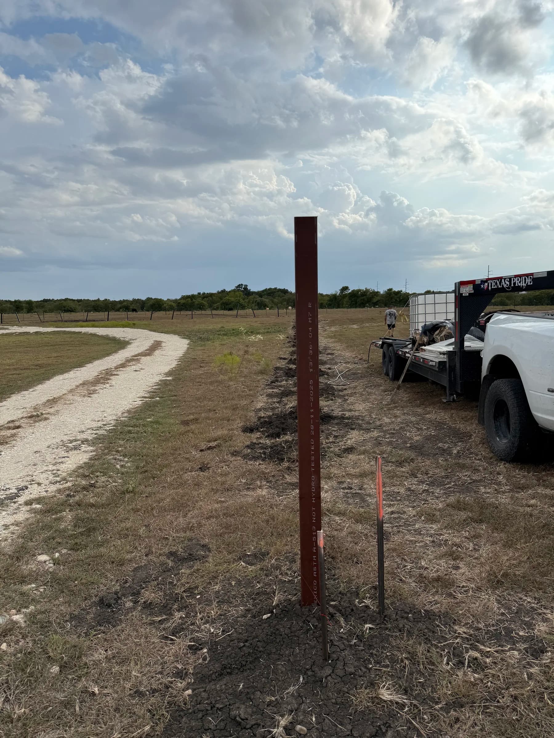 Steel fence posts set beside the gravel drive in Holland