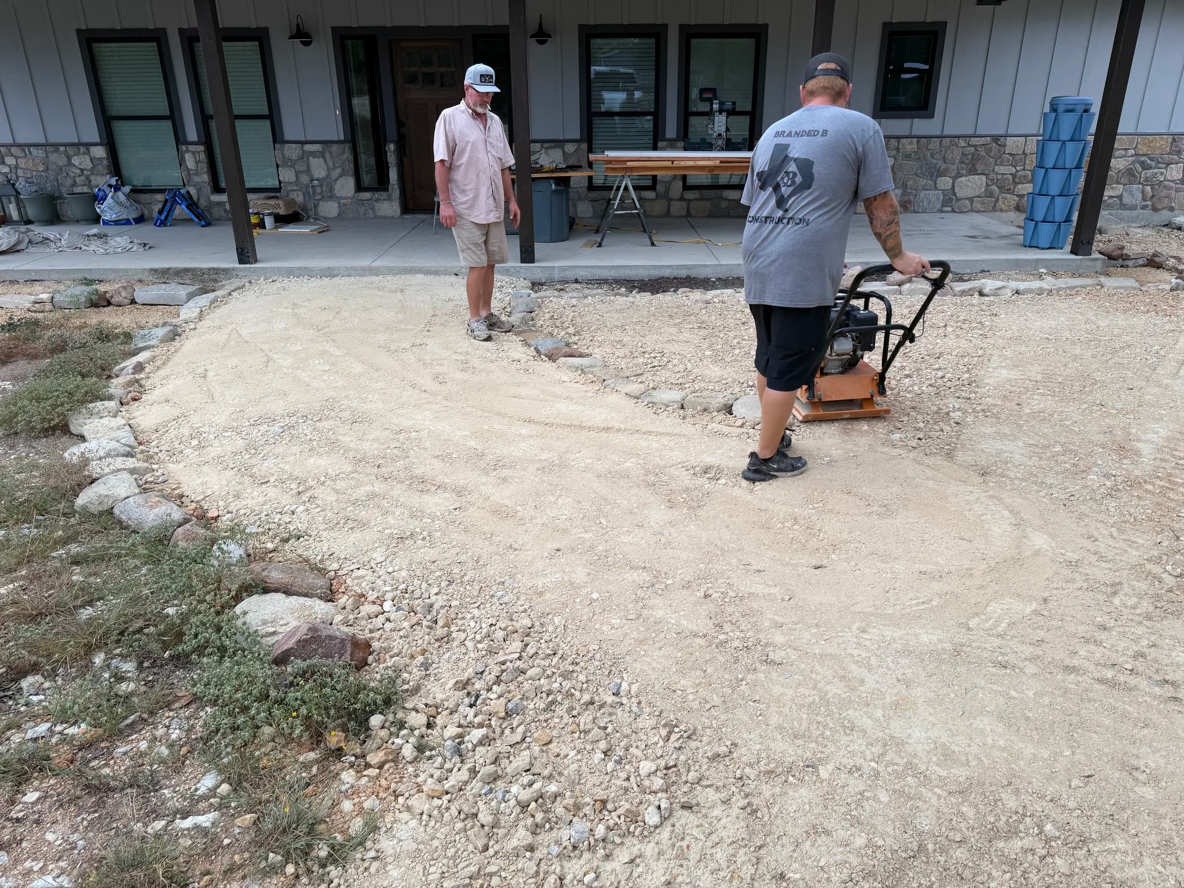 Branded B crew compacting aggregate beside the home at the Ding Dong project